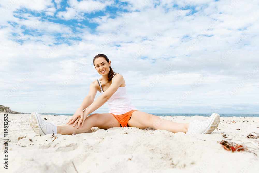 Young woman training on beach outside