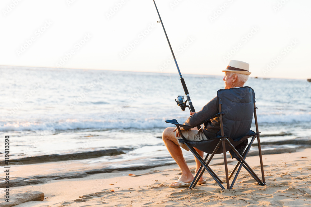 Senior man fishing at sea side Senior man fishing at sea side