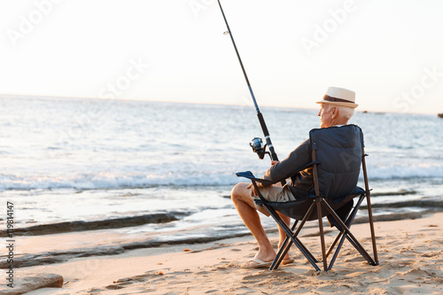Senior man fishing at sea side