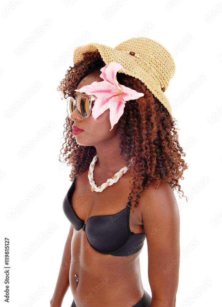 A black woman in bra and straw hat. A black woman in bra and straw hat.