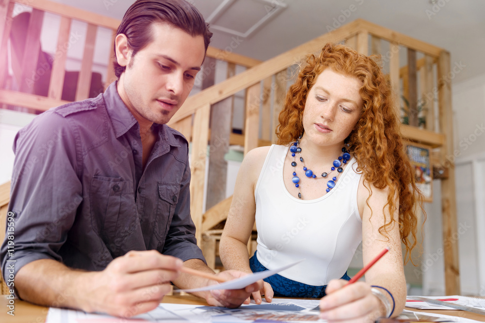 Obraz premium Two young architects in office