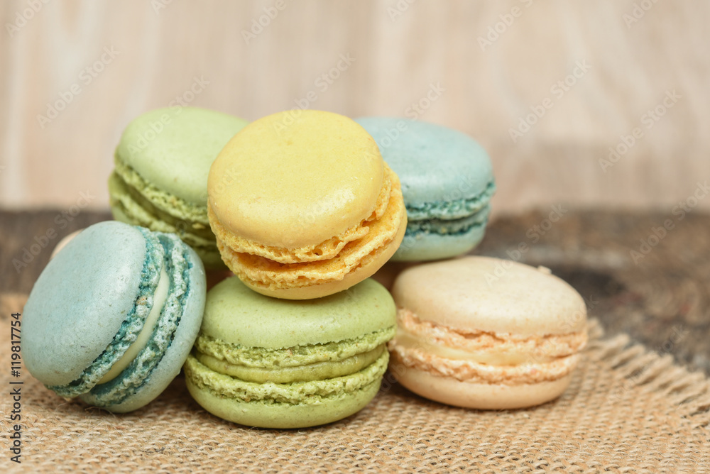 Macarons piled on burlap napkin in rustic setting Macarons piled on burlap napkin in rustic setting