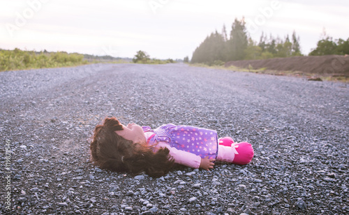 Concept Abandoned Person,Abandoned doll laying on road,vintage t