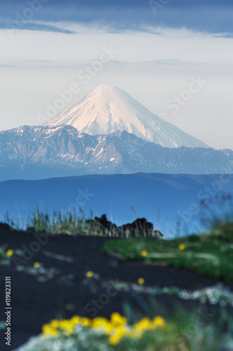 Beautiful summer volcanic landscape of Kamchatka Peninsula: view of active Kronotskaya Sopka (Kronotsky Volcano) in good weather at sunrise. Eurasia, Russian Far East, Kamchatka Region. photo