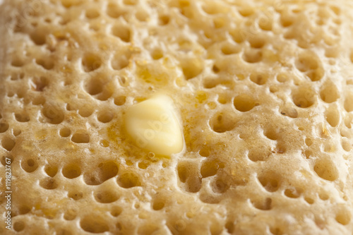 close up crumpet with butter