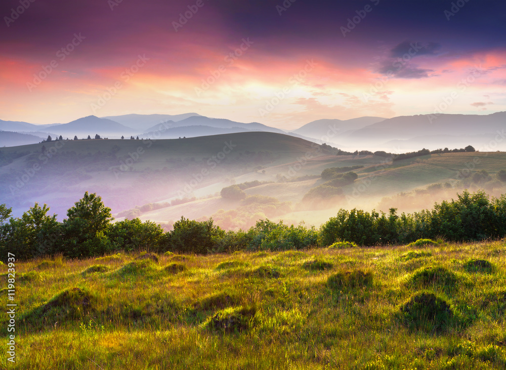 Colorful scene in foggy mountains