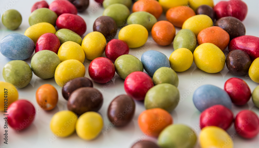 colored chocolate drops on white background colored chocolate drops on white background