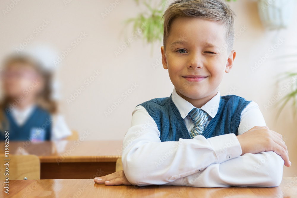 Happy schoolboy sitting at desk Happy schoolboy sitting at desk