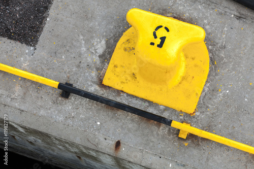 Yellow port mooring bollard with number 5 label