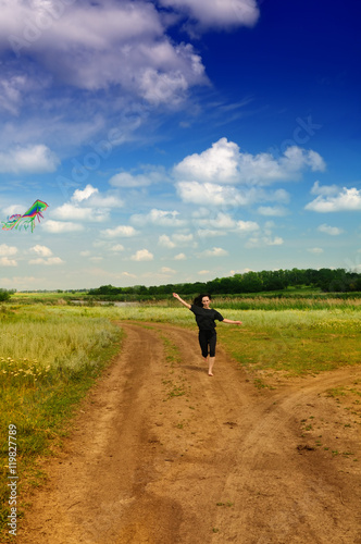 Girl flying a kite in a field