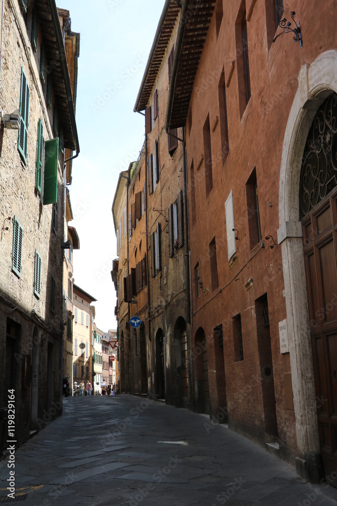 Narrow old alley in Siena, Tuscany Italy 