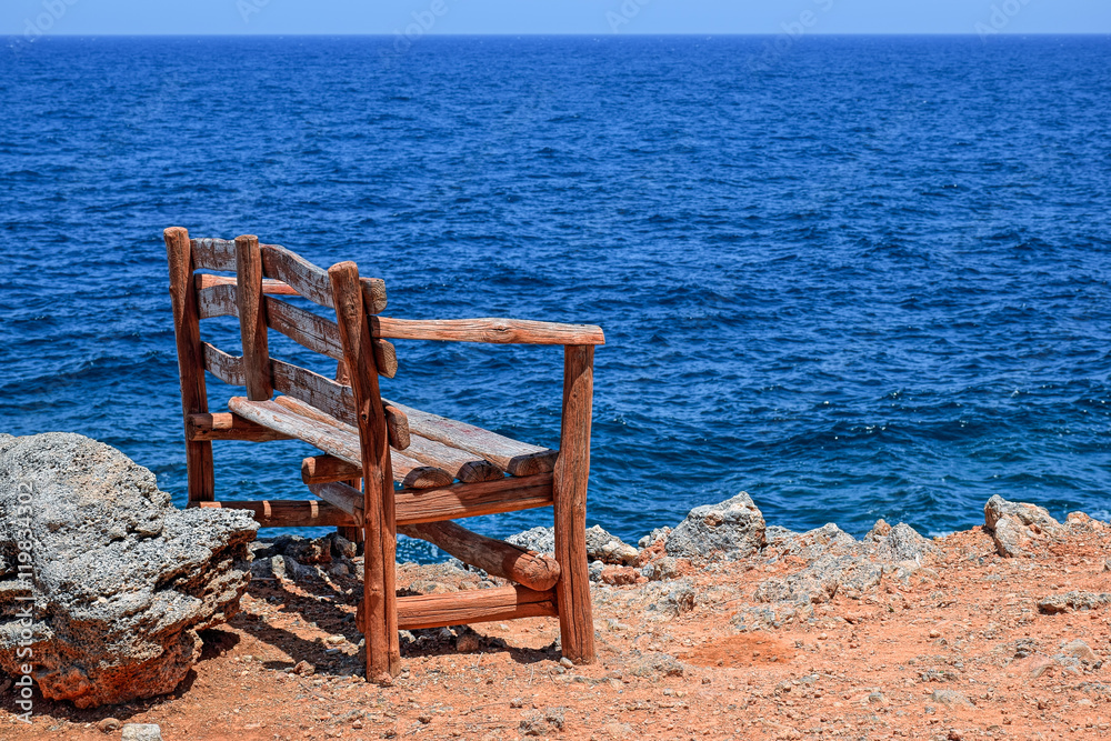 Alone bench on sea shore
