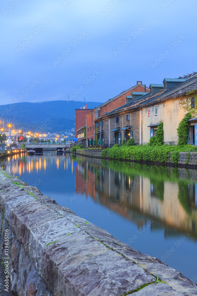 Fototapeta premium Otaku, Japan historic canal and warehouse in summer twilight time, famous tourist attraction of Sapporo Hokkaido.