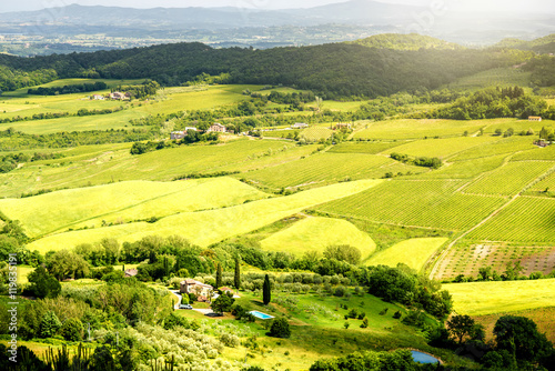 Beautiful tuscan landscape view on the green meadow with farmlands near Montepulciano town in Italy