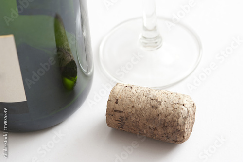 Wine cork alongside a bottle and glass