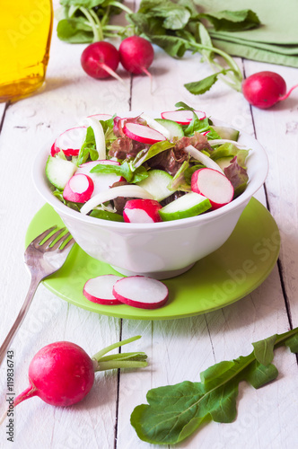 Vegetable salad with radish in a white bowl