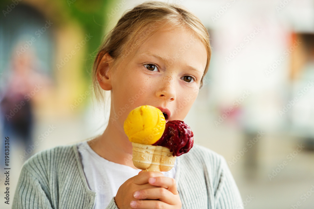 Cute little girl eating ice cream outdoors Cute little girl eating ice cream outdoors