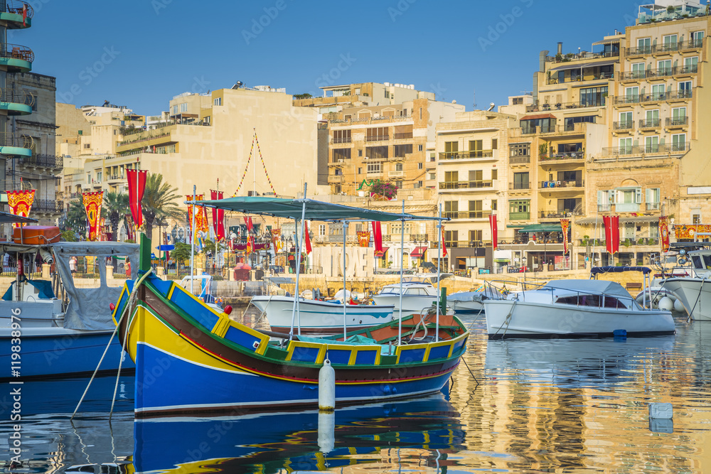 St.Julian's, Malta - Colorful Luzzu fishing boats in Spinola bay at sunrise