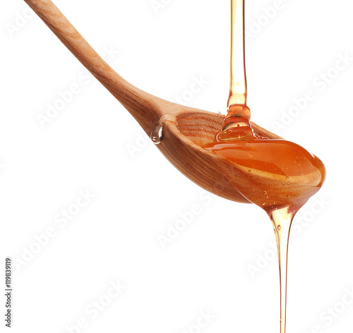 Wallpaper Mural Honey dripping from a wooden honey dipper isolated on white back Torontodigital.ca