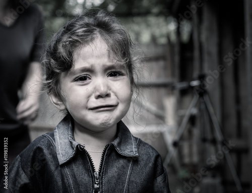 The child - a girl crying. In the eyes visible tears.
