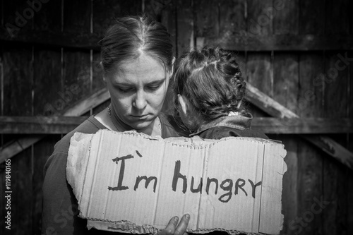 A woman with a child holding a sheet of paper. On the paper label sheet, 