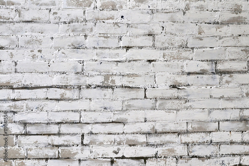 old brick wall with smeared white paint