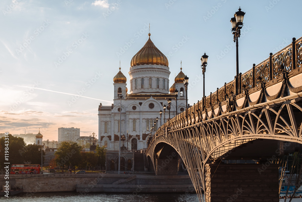 Famous christian landmark in Russia - Christ the Savior cathedral, sunset view from gorgeous metal bridge, autumn in Moscow
