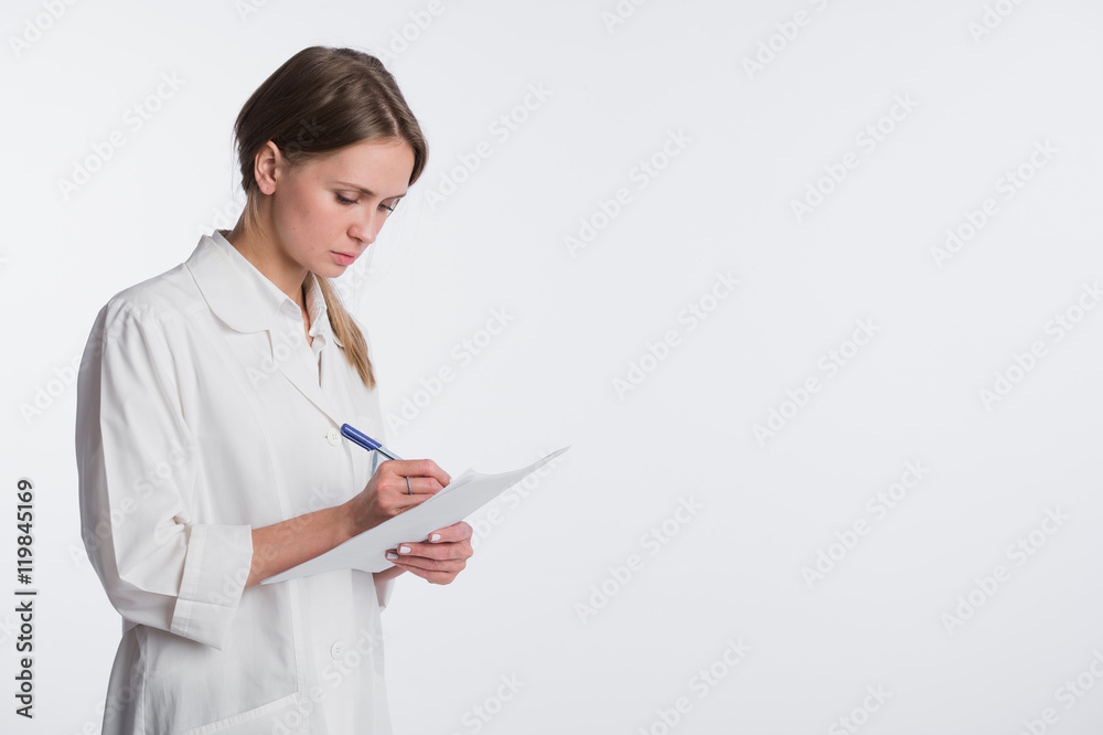 Cheerful medical doctor woman taking notes. Isolated on white Cheerful medical doctor woman taking notes. Isolated on white