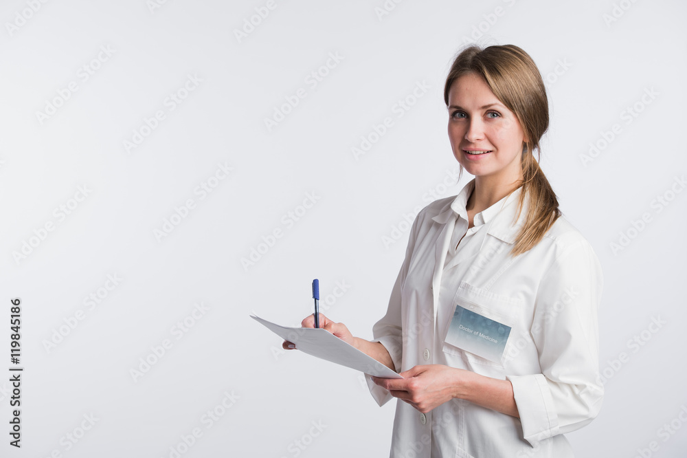 Cheerful medical doctor woman taking notes. Isolated on white Cheerful medical doctor woman taking notes. Isolated on white