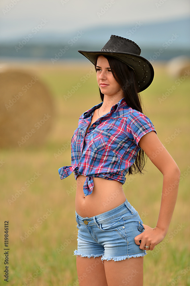 Young american cowgirl woman portrait outdoors. 