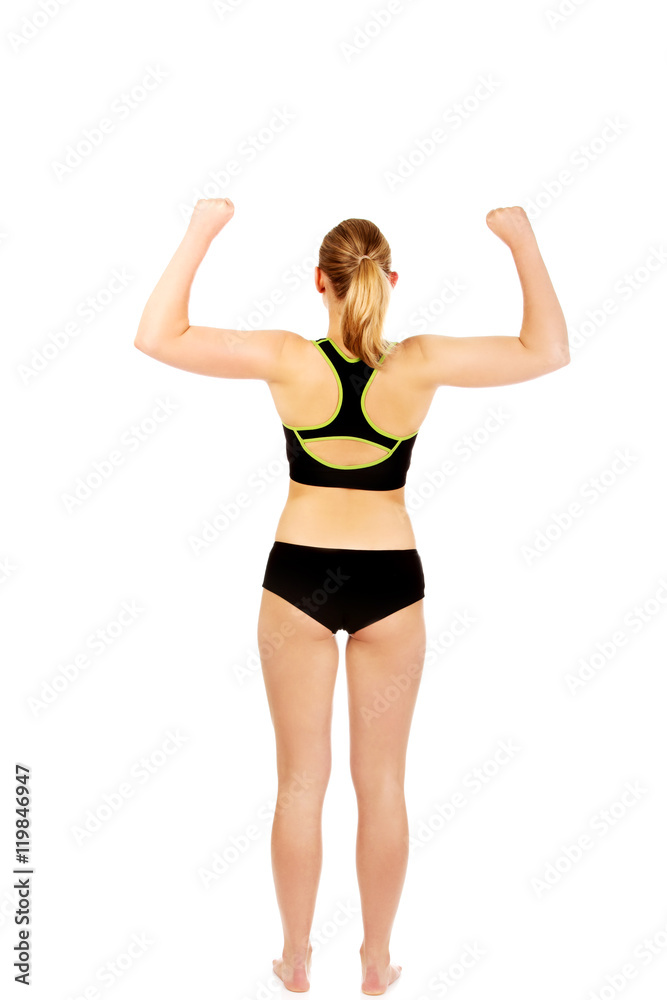Back view of athletic woman showing muscles Back view of athletic woman showing muscles