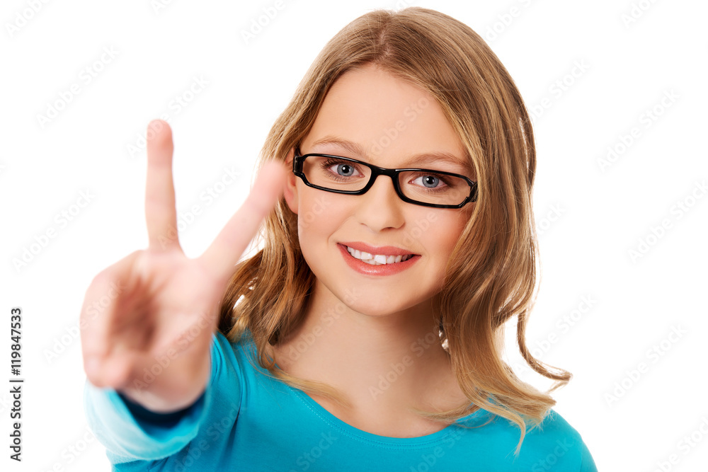 Happy teenager showing victory sign