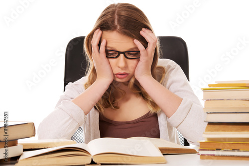 Young woman with a books pile