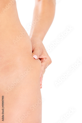 Slim woman pinch skin on hip