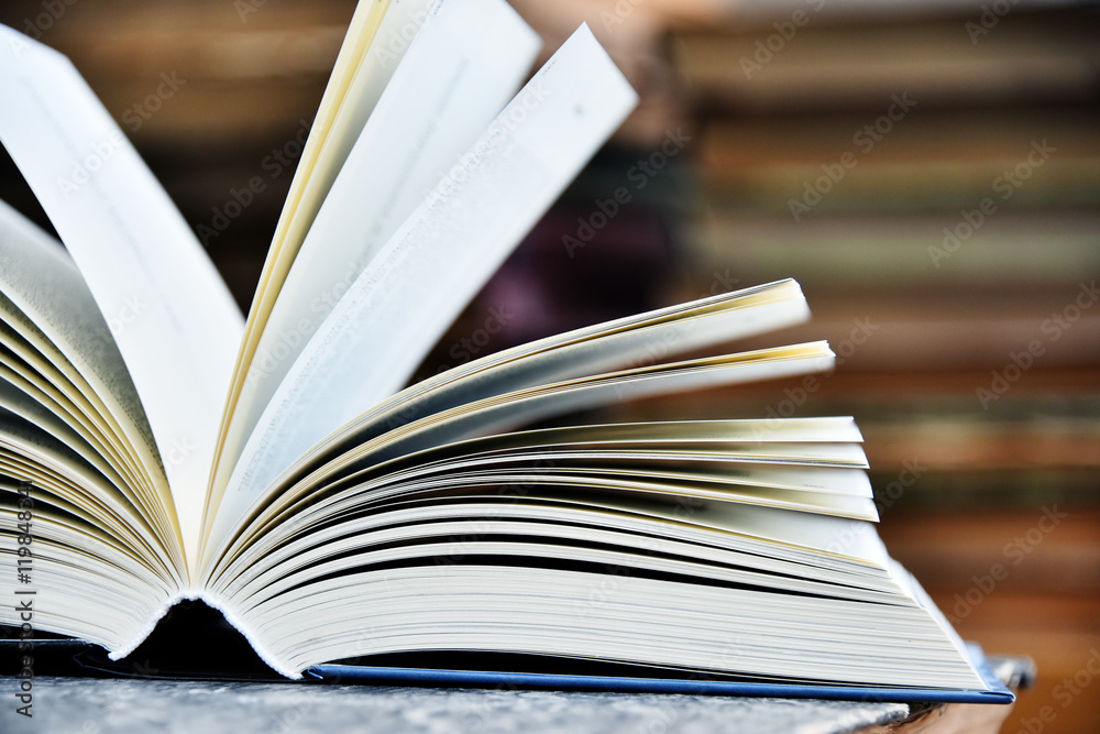 Fototapeta premium Hardcover book lying on the table in a library