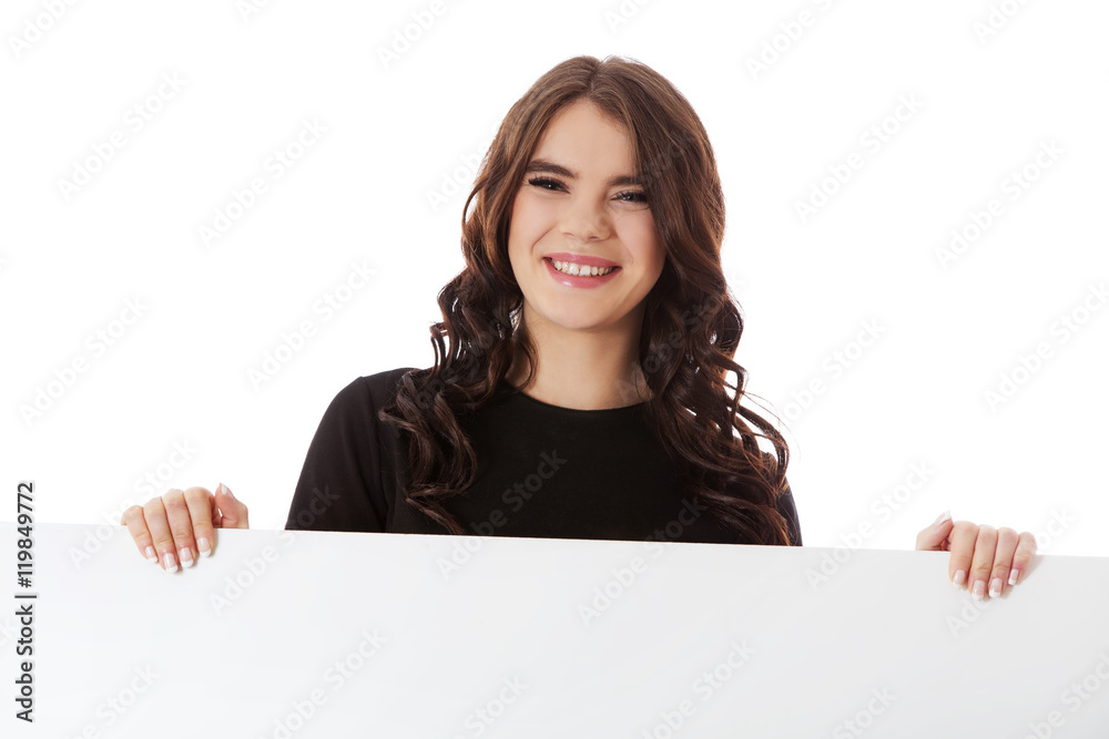Smiling young business woman holding blank signboard Smiling young business woman holding blank signboard