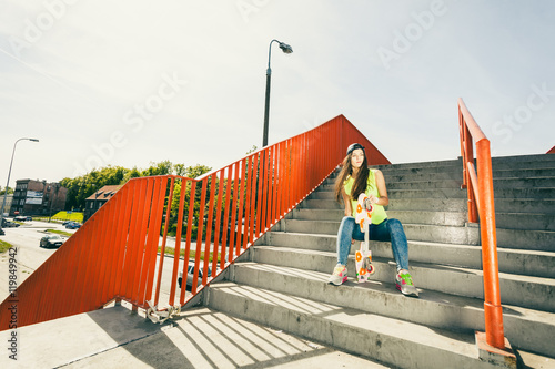 Girl on stairs with skateboard. © Voyagerix