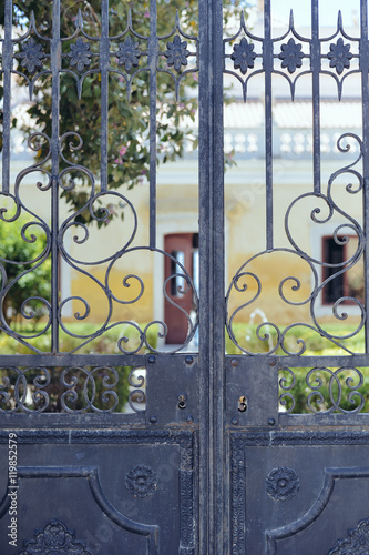 Closeup detailt of beautiful old ornate metal door outdoors background photo