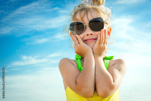 A Girl in Sunglasses On a Background Of Blue Sky