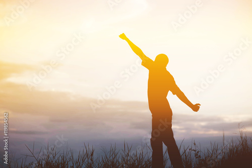 Men, who welcome sunrise with raised hands and enjoying landscap