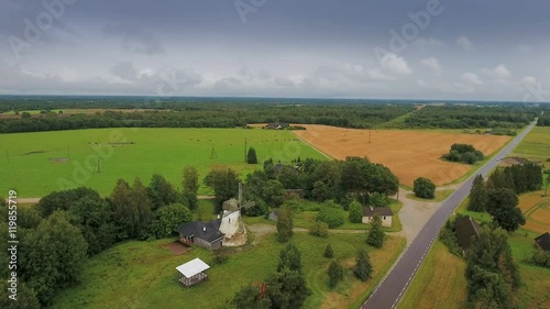 Closer look of the windmill in Muuga with the agri crop field on the side and the forest in front photo