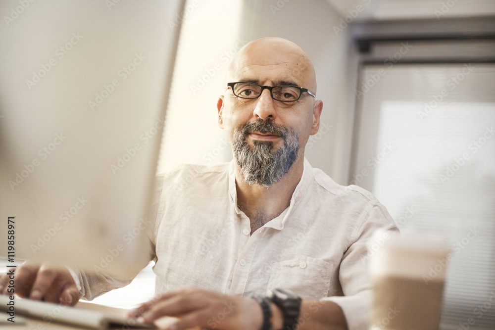 Senior businessman working on computer Senior businessman working on computer