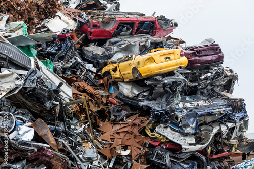 Dumping ground. Scrap metal heap. Compressed crushed cars is returned for recycling. Iron waste ground in the industrial area. Stacked automobile