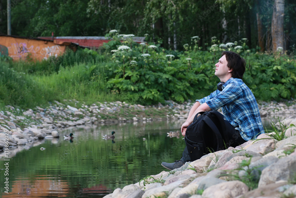 man sit on stone river man sit on stone river