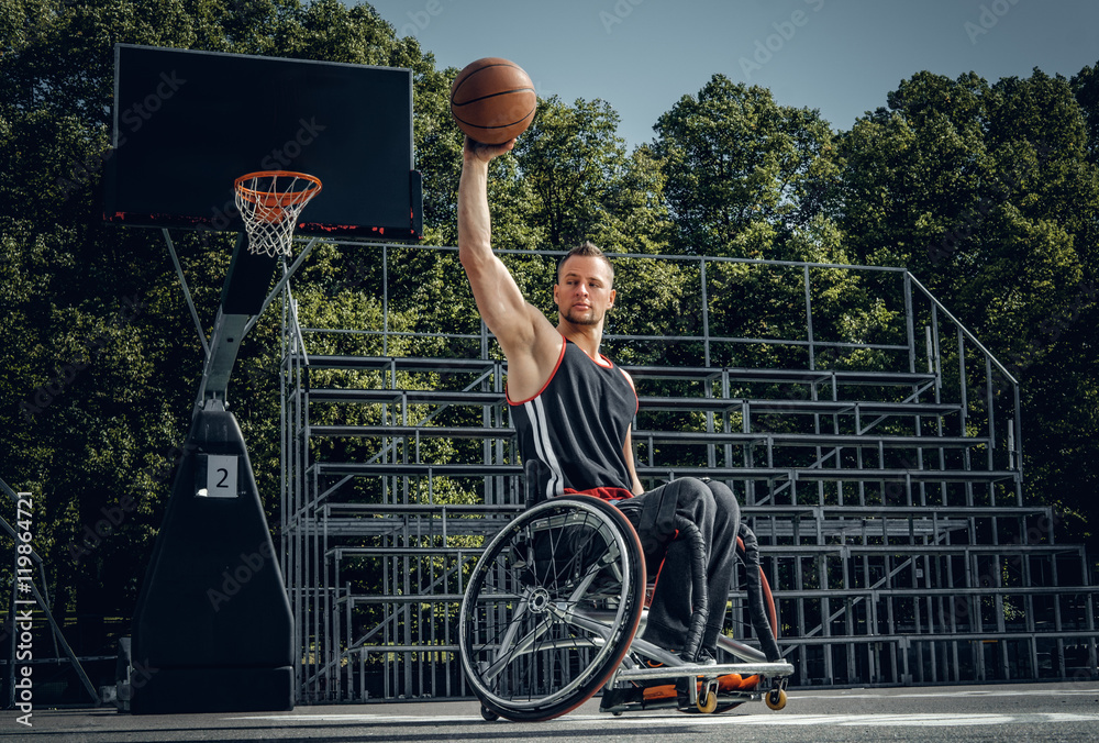 Fototapeta premium Cripple basketball player in wheelchair plays basketball.