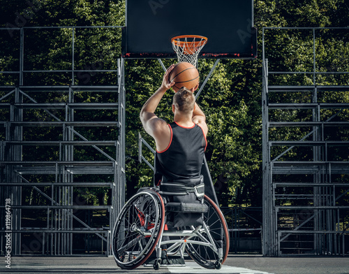 Cripple basketball player in wheelchair plays basketball.
