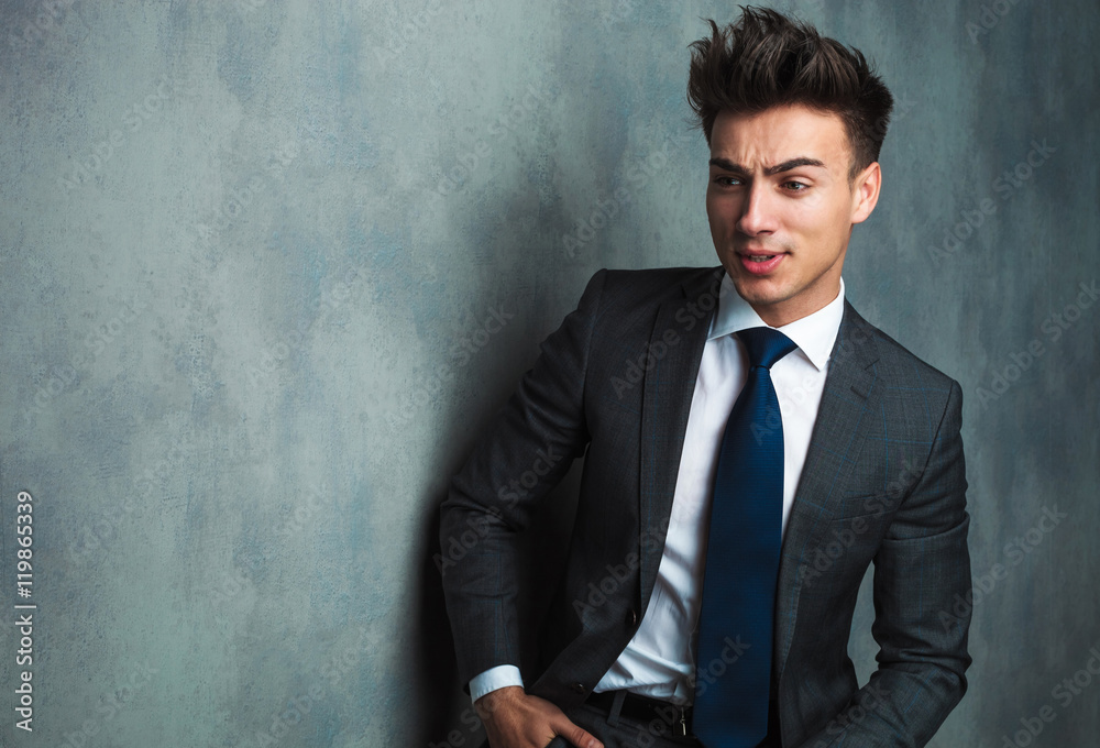 angry young businessman sitting and looking away angry young businessman sitting and looking away