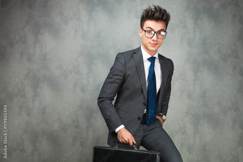 walking young business man holding a briefcase walking young business man holding a briefcase
