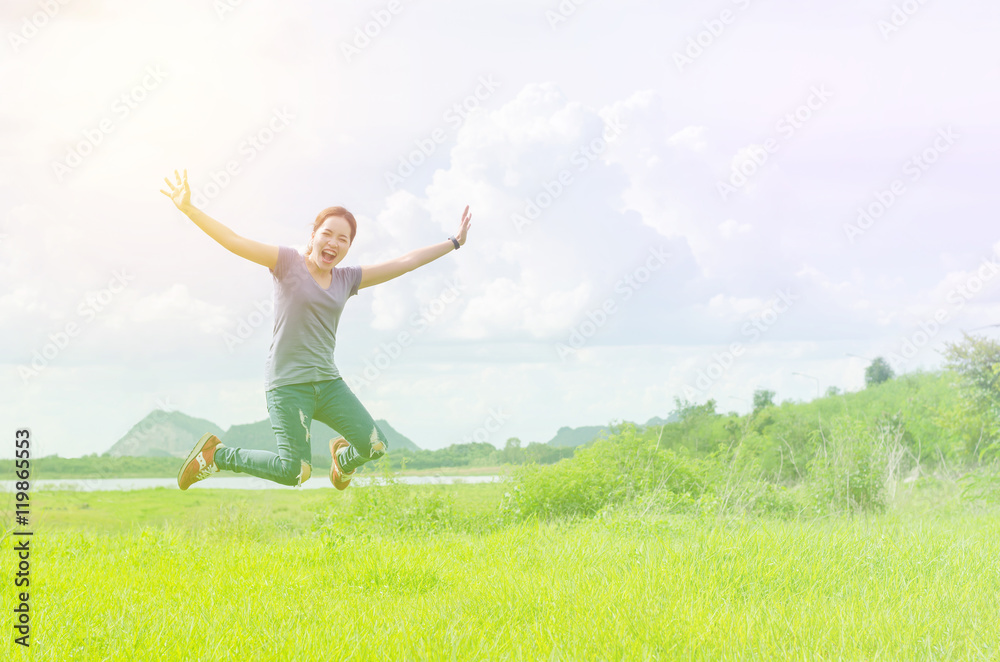 Young asian girl jump in the meadow with vintage filter Young asian girl jump in the meadow with vintage filter