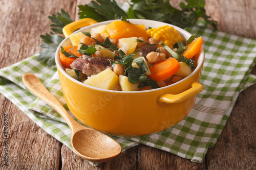 Pouchero hot dish Close-up in a pot on the table. Horizontal
 photo